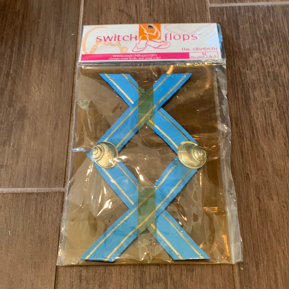 BRAND NEW in package “The Elizabeth” Switch Flops light blue w/gold shells.